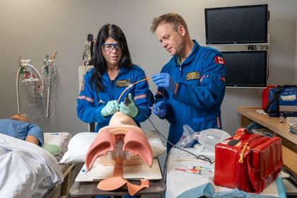 Two STARS air medical crew members, one trainee and one educator, work on intubation training during a training session at a STARS base.