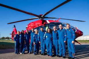 STARS operations staff pose alongside STARS Rescue on the Prairie participants in front of a STARS air ambulance helicopter at this year's event.
