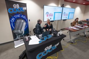 A member of STARS clinical education staff is interviewed by the program host from 98 Kool FM during the 2026 Critical Care on the Air Raditothon