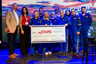 STARS President and CEO Dr. John Froh stands alongside Field of STARS Committee Chair Nicole Denty and STARS operations staff holding a giant cheque showing the $725,000 raised during the Field of STARS 2026 signature event.