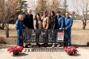 Family of Vickie and Eugene Sebulsky, STARS legacy donors, are pictured with STARS staff at the unveiling of a memorial bench in Morrison Park in Yorkton, Saskatchewan. From left to right: STARS Chief Clinical Officer Cindy Seidl, STARS President and CEO Dr. John Froh, Sebulsky family members Michelle Stuckel, David Stuckel, Maurie Andrew and Derek Andrew, and STARS Provincial Director, Manitoba/Saskatchewan Operations Grant Therrien.