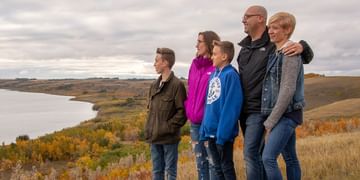 STARS Very Important Patient Adair O'Grady poses with his wife and kids atop a hill overlooking a body of water in this fall photo.