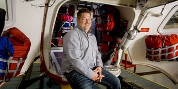 STARS Very Important Patient Chad Rogers sits in the open rear doors of a STARS air ambulance helicopter in this older photo.