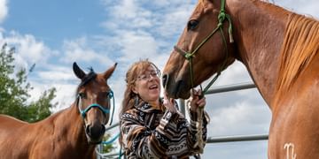 STARS very important patient Cindi Long with her horses on her ranch on a sunny day.