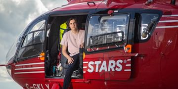 STARS Very Important Patient Draedon Faubert sits in the open side door of a STARS air ambulance helicopter during a visit to his nearest STARS base.