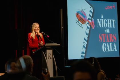 A speaker at a podium at a past A Night with STARS event.