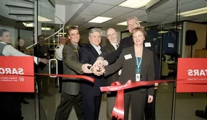 STARS founder Dr. Greg Powell is photographed with at the time leader of the STARS Emergency Link Centre (ELC) and other dignitaries during the ribbon cutting of the new ELC space in Calgary in the late-1990s