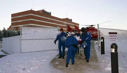 STARS crew maneuver a stretcher through a gate during the early days of STARS operations in Grande Prairie.