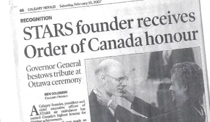 A photocopy of a newspaper headline announcing that Dr. Greg Powell had received the Order of Canada