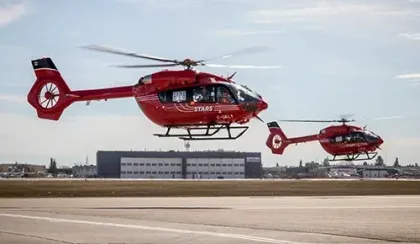 Two STARS liveried Airbus H145 helicopters hover off the ground at an event welcoming the first of their kind to Calgary operations.