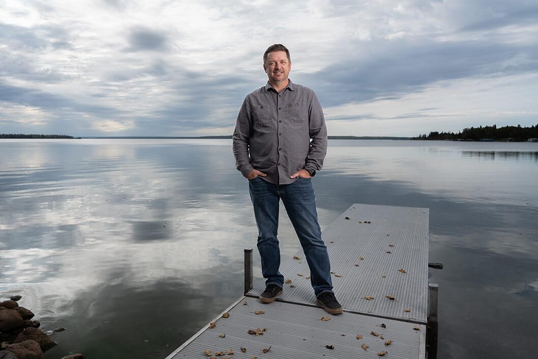 STARS Very important Patient Wade Cassidy stands on the dock on the lake of his summer cabin.