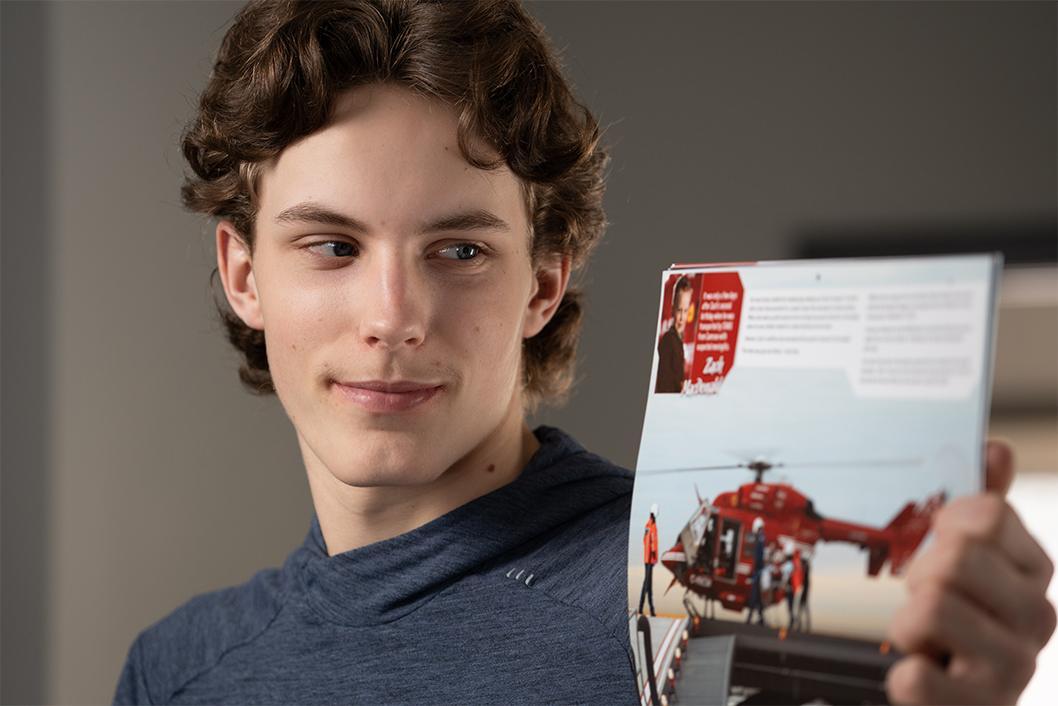 STARS Very Important Patient Zach MacDonald holds a copy of a STARS calendar in which he was featured as a boy.