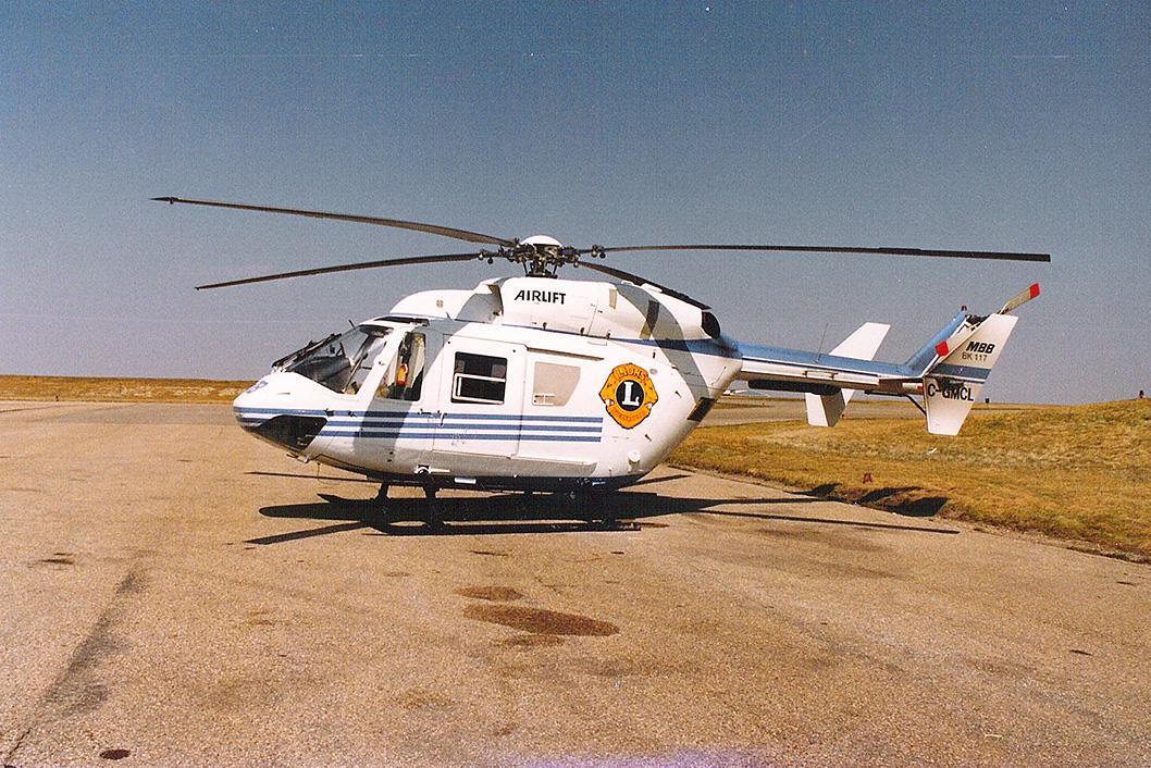 Archival image of the first BK117 STARS used, with Lions Club International livery and logo on the sides of the helicopter.