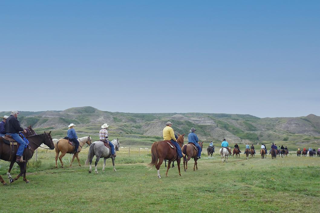 Participants of a past Rumsey Ride horseback riding fundraiser ride across the prairie for an event In Support of STARS