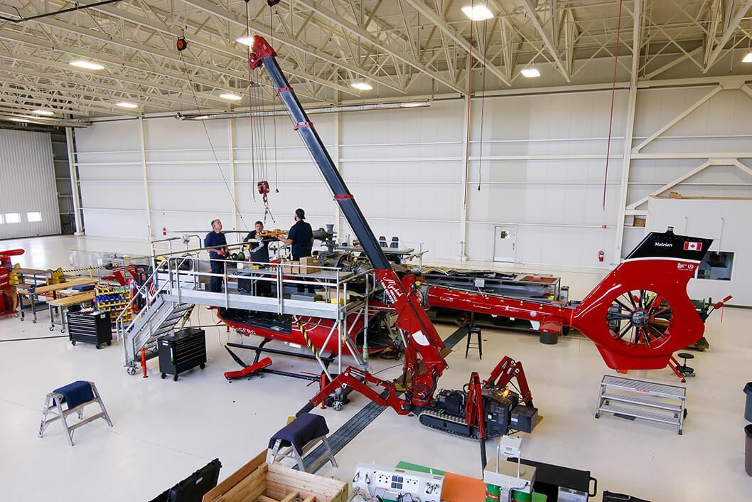 STARS engineering staff work atop C-GFRG, a STARS H145 air ambulance, while it undergoes a conversion to the D3 variant, replacing the four blade rotor with a five blade rotor, amongst other changes.