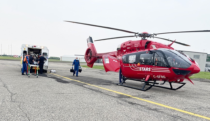 A patient is transfered from a ground Ambulance to STAR-9 from Regina at the Brandon Manitoba airport