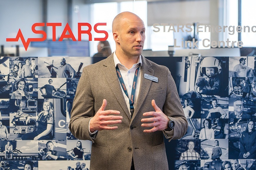 STARS Emergency Link Centre Director John Griffiths gives a short presentation to a tour group (not pictured) standing in front of the newly unveiled Very Important Patients collage.
